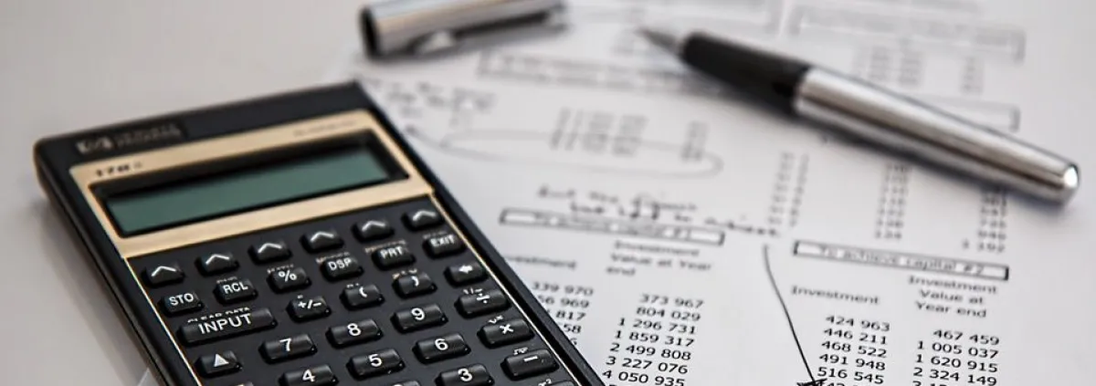 Calculator and pen on sheet